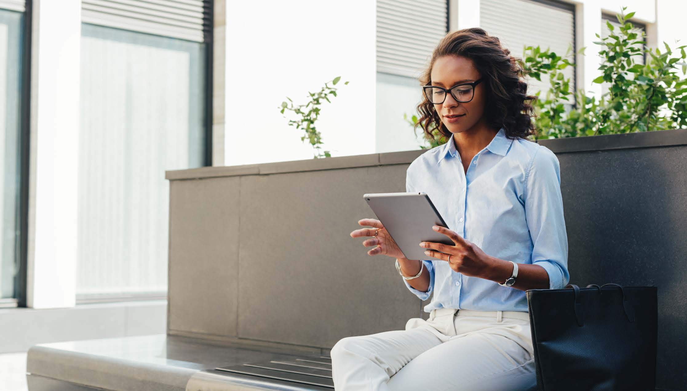 Woman Sitting Outside Using iPad