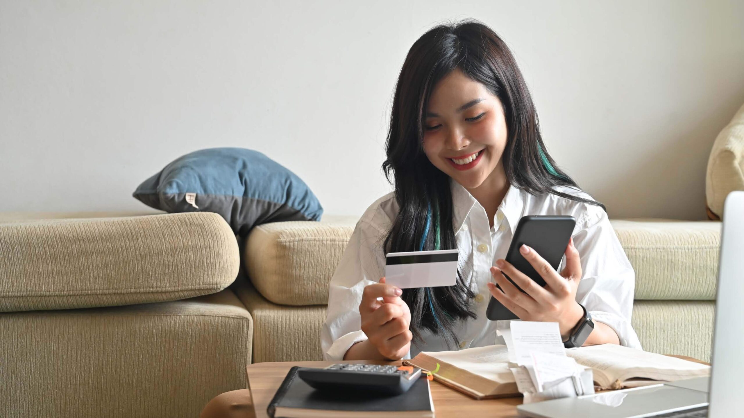 Girl Checking Bills On Phone Zelle_PB co-branded logo